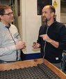 Mogens Christensen (left) is conducting research to develop more efficient and sustainable magnets. Among those he is working with is Peter Kjeldsteen (right), head of development at the company Sintex. The black rings in the picture are magnets for elect